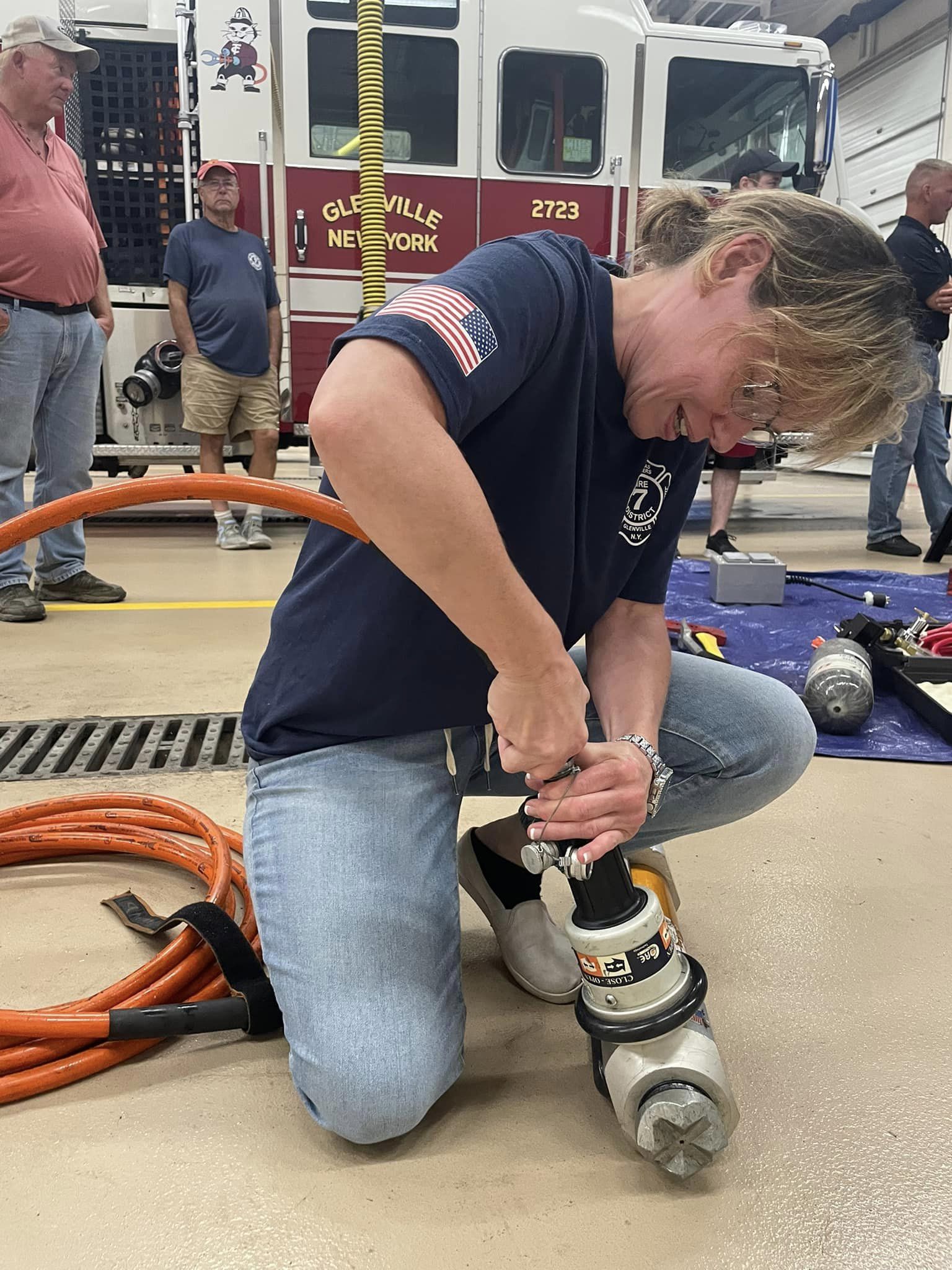 female firefighter fixing equipment