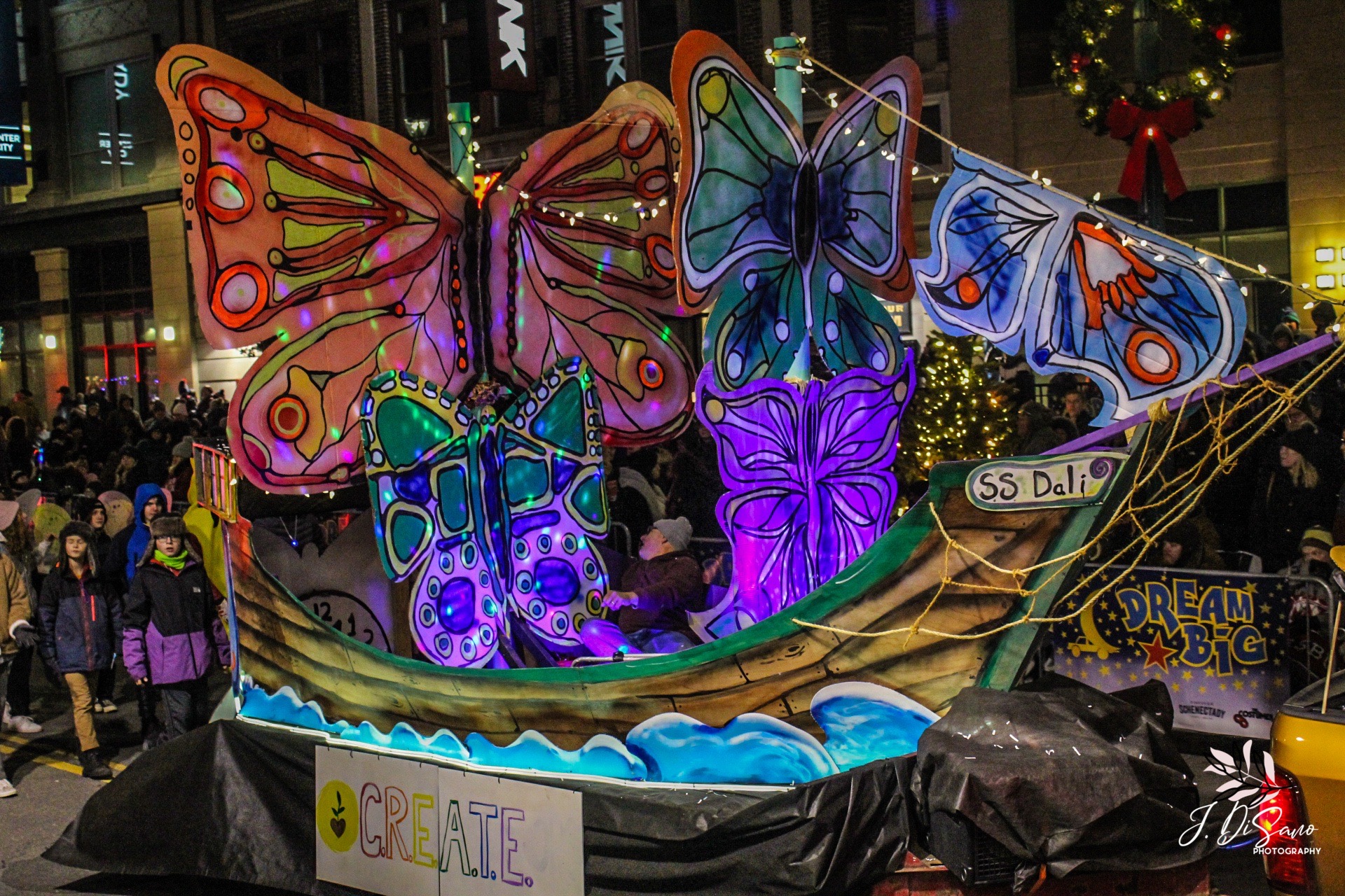 The SS Dali! A colorful float featuring a pirate ship, brightly colored butterflies, and LED lights. Designed and built by C.R.E.A.T.E. Community Studios.