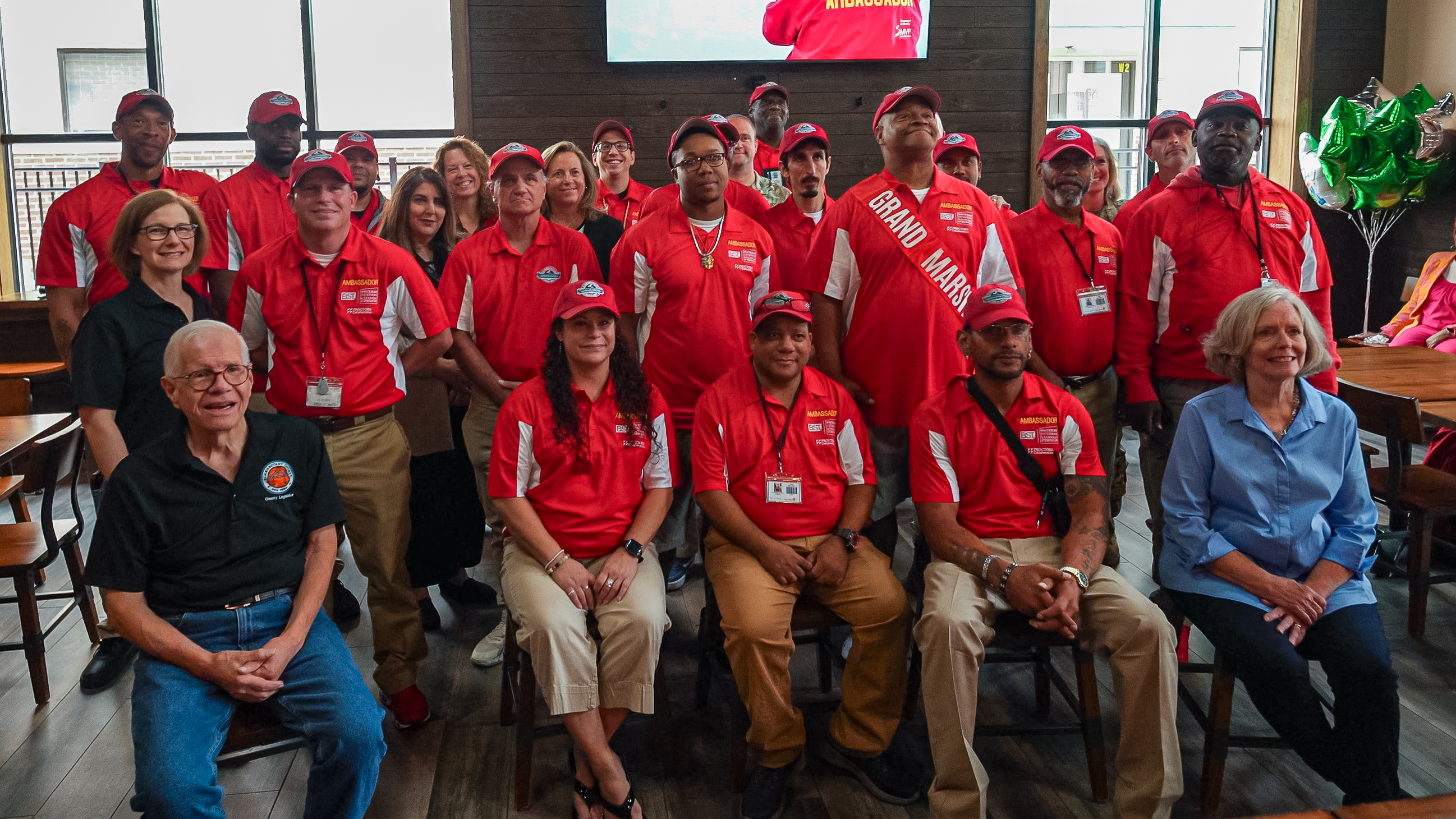 photo of Downtown Ambassadors in their red uniforms at the Grand Marshal announcement.