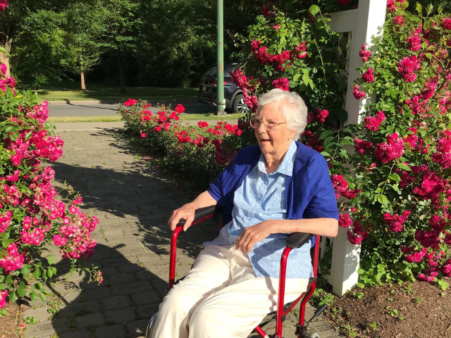 Alice Howes (95) sits in her wheelchair at the entrance of the Central Park Rose Garden in Schenectady. 