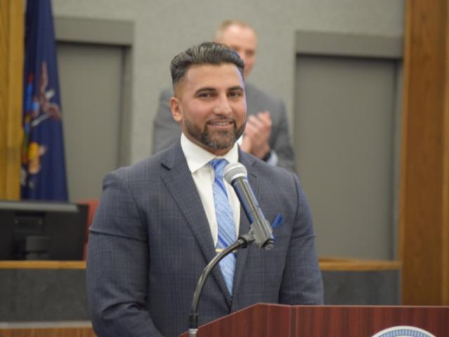 Photo of Newly Appointed District 2 County Legislator Raj Ishmael Smiling at the Podium