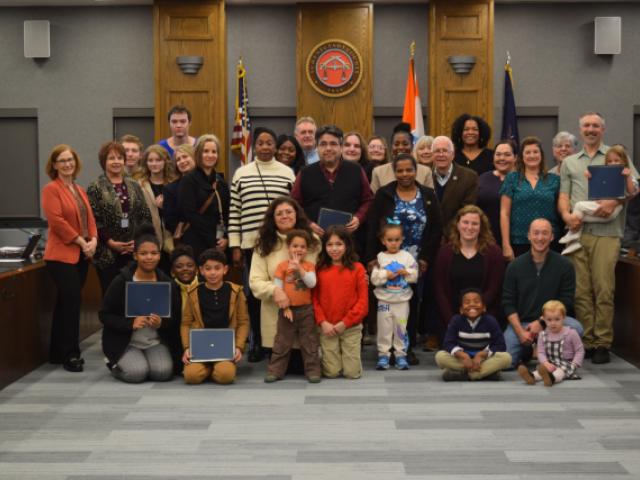 Photo of County Legislators Hughes and Ostrelich with DSS Staff, kids and their adoptive families