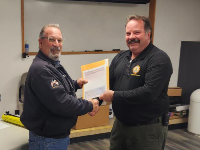 Photo of Deputy Fire Coordinator Dale Lingenfelter presenting a fire grant to a local fire department