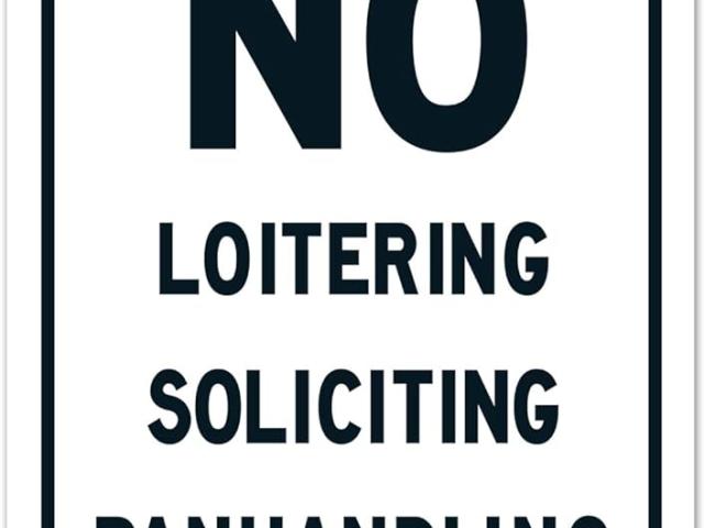 Sign saying No Loitering Soliciting Panhandling