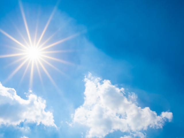 Picture of bright sun and clouds with a blue sky