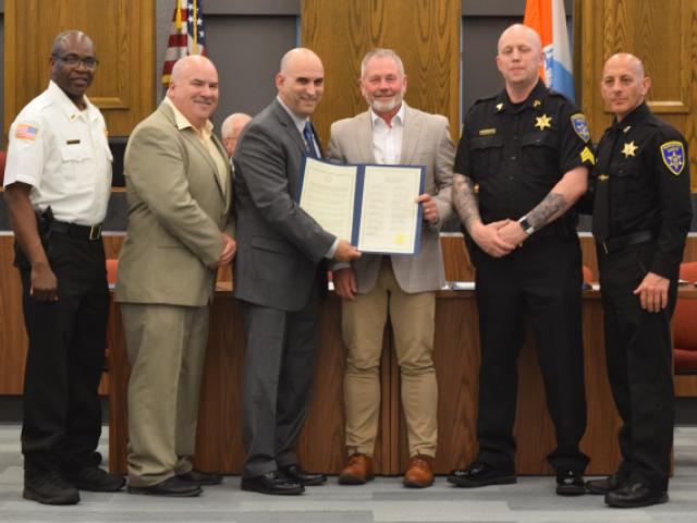 Schenectady County Sheriff Dagostino receives a proclamation from Schenectady County Legislator Tom Constantine