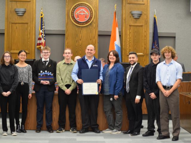 Photo of members of the Mohonasen Marching Band accepting an award from County Legislator Cathy Gatta